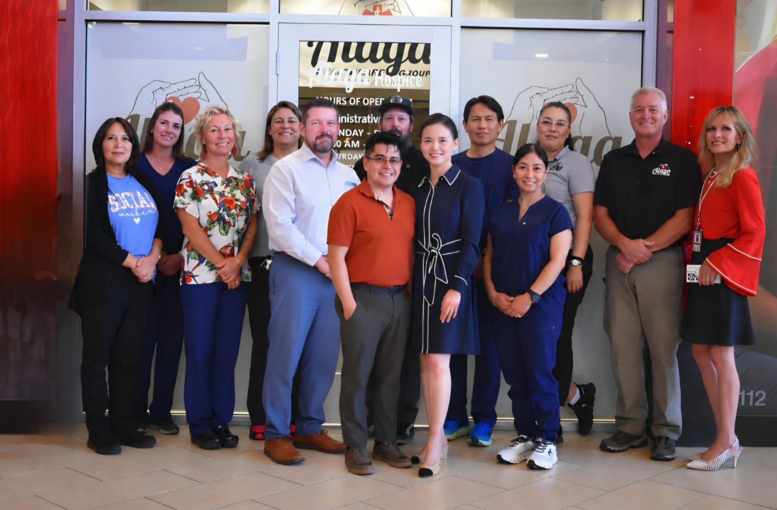 Alaga Healthcare team standing together in front of the office entrance